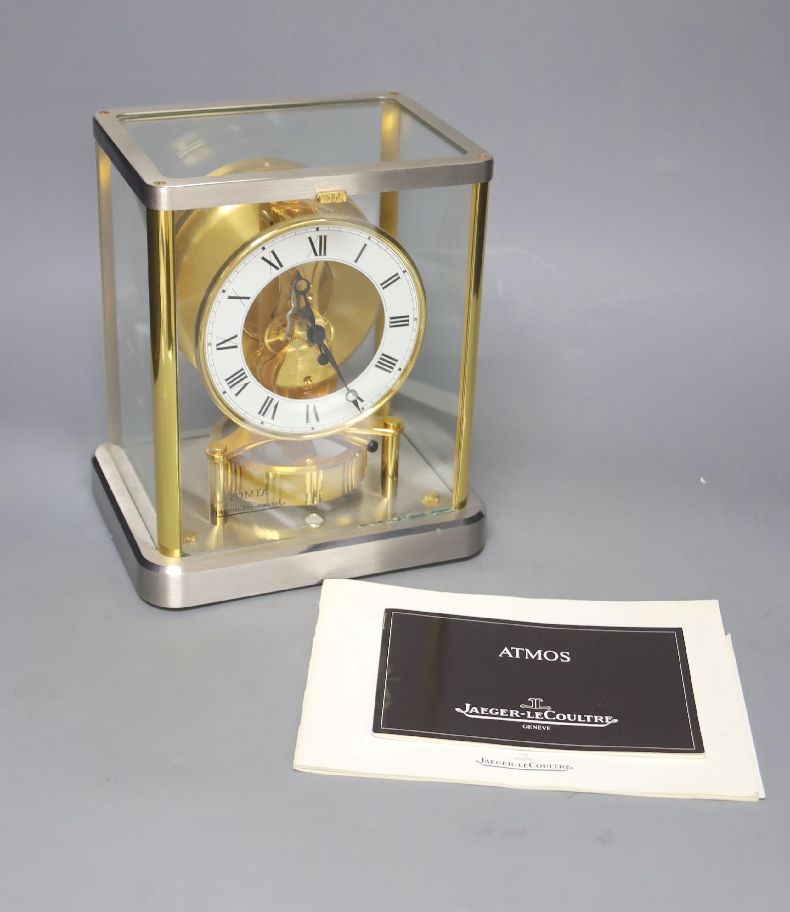 A Jaeger le Coultre Atmos mantel clock, in silvered and gilt metal glazed panelled case, height 23cm
